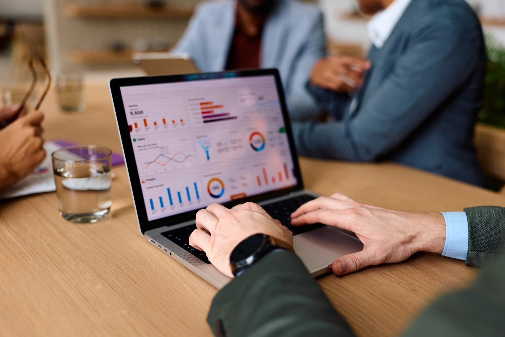 Business leader reviewing financial analytics on a laptop during a Budget strategy meeting.