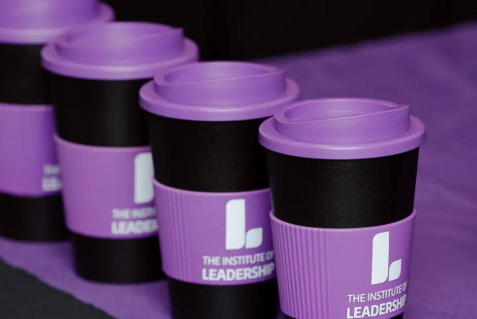 The Institute of Leadership promotional table with branded travel cups.